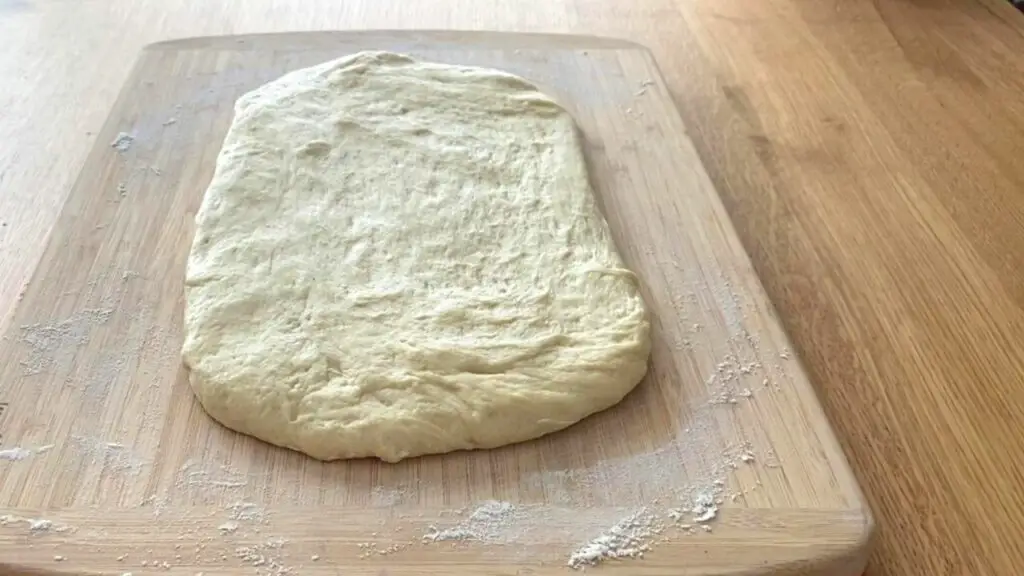 spread dough on floured surface