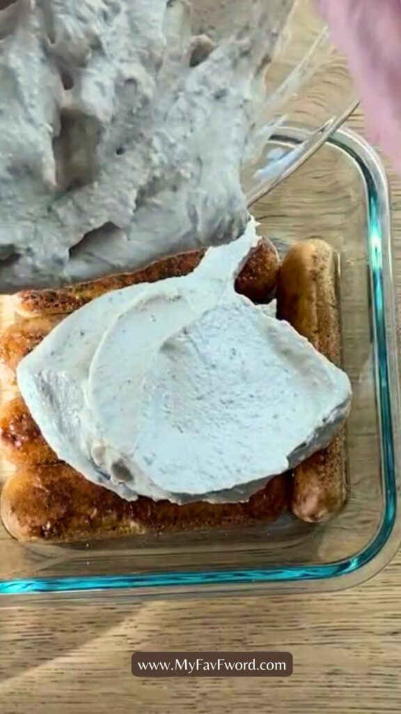 pouring yogurt on lady fingers dipped in coffee